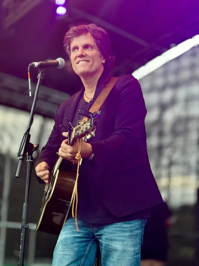 Lionel Fornetti singing and playing guitar on stage