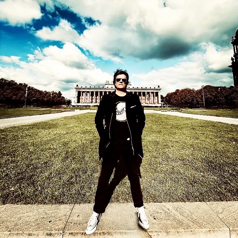 Lionel Fornetti standing on a lawn in front of a neoclassical building