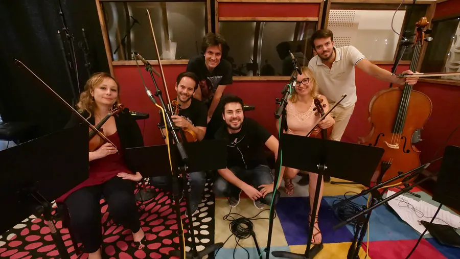 String players gathered in a recording studio