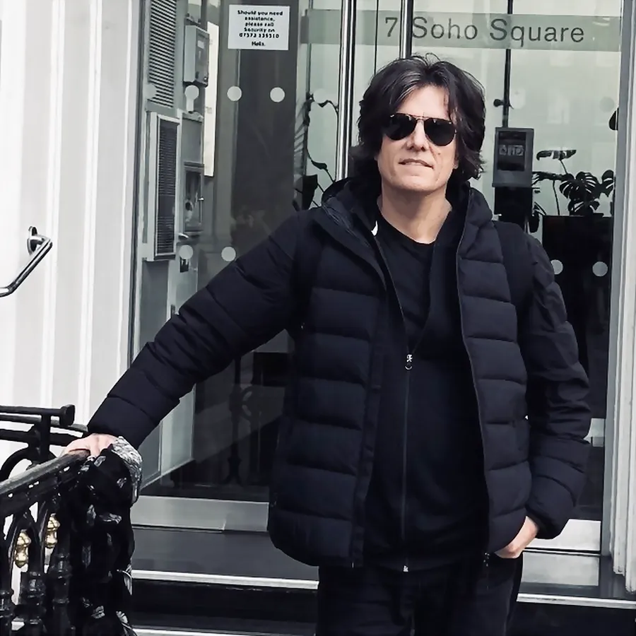 Lionel Fornetti in sunglasses and a black jacket in front of 7 Soho Square