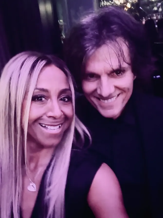Lionel Fornetti smiling with a woman, purple light